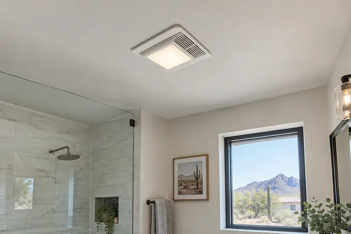 Quiet ceiling exhaust fan with a built-in light in a newly remodeled bathroom ceiling